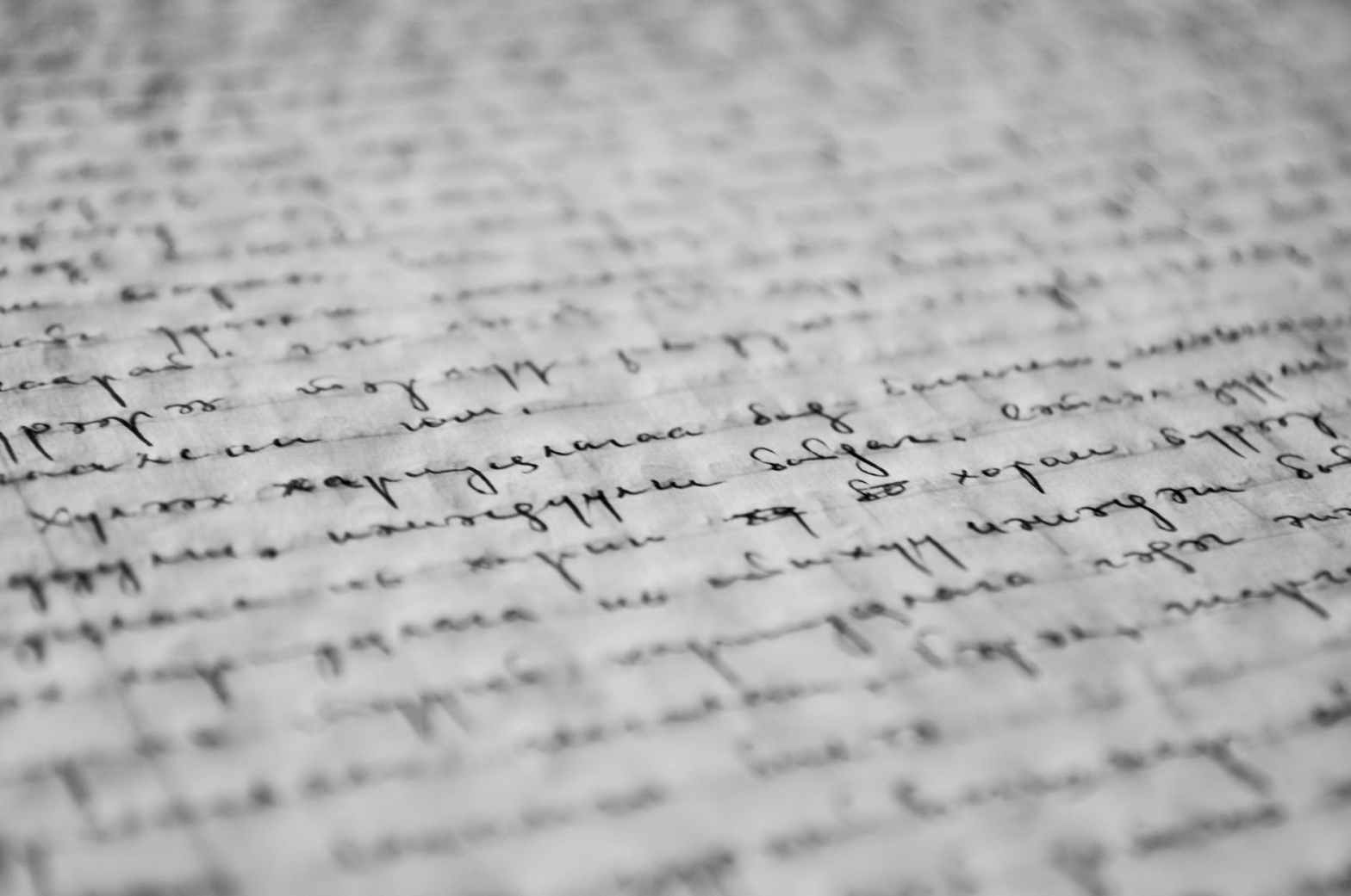 Image description: handwritten words on a page, out of focus.